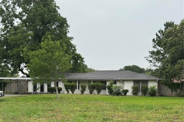 view of front of house with a front yard and fence