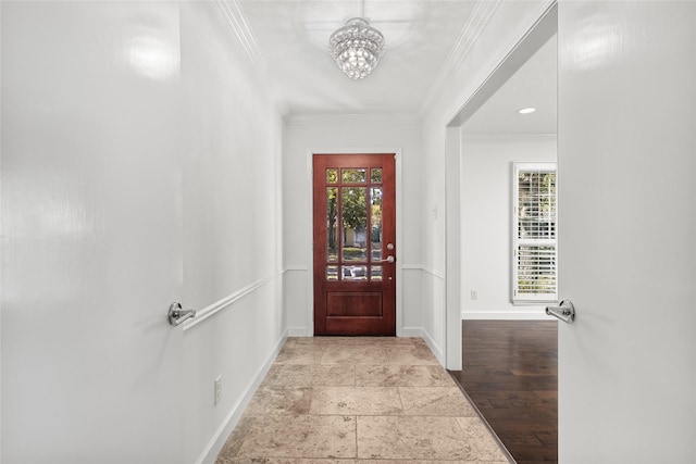 entrance foyer with a notable chandelier and ornamental molding