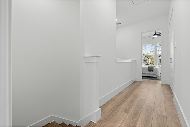 hallway with light hardwood / wood-style flooring