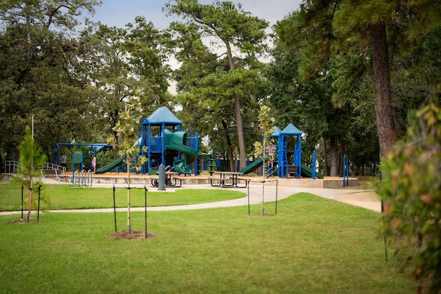 view of jungle gym featuring a lawn