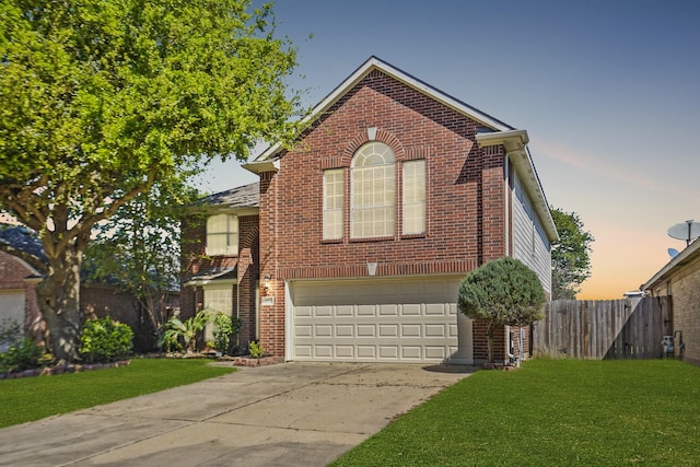 front facade featuring a lawn and a garage