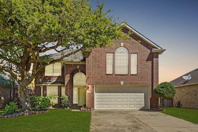 view of front of home featuring a garage and a lawn