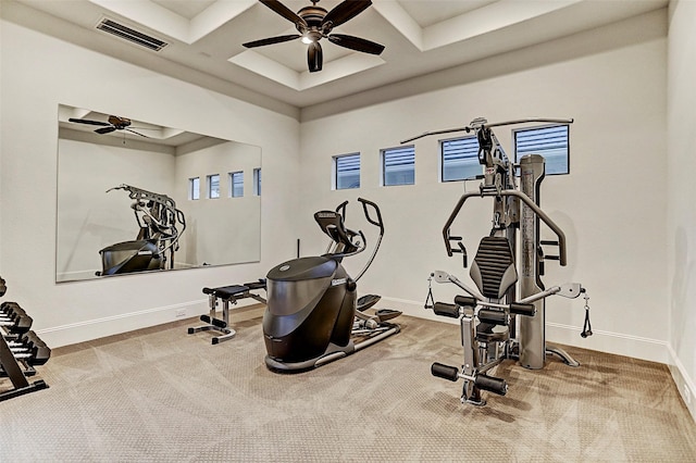 workout area featuring carpet flooring, ceiling fan, and coffered ceiling