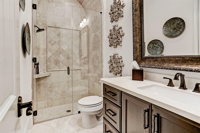 bathroom with a shower with door, vanity, and toilet