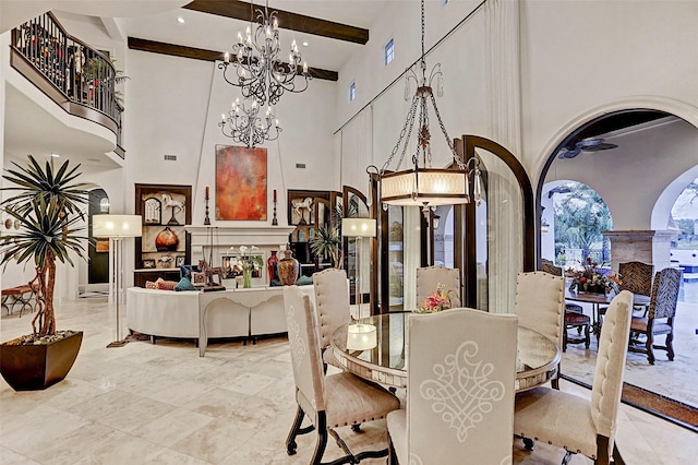 dining area with beamed ceiling and a high ceiling