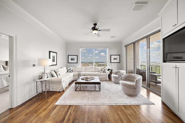 living room with dark hardwood / wood-style flooring, plenty of natural light, and ceiling fan