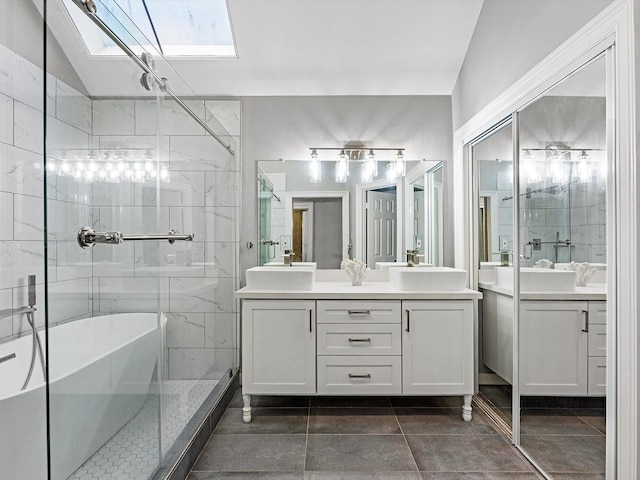 bathroom with vanity, lofted ceiling with skylight, and separate shower and tub