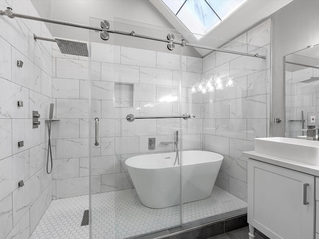 bathroom featuring separate shower and tub, vaulted ceiling with skylight, vanity, and tile walls