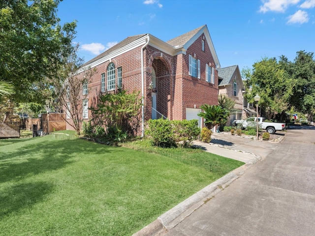 view of side of property with a garage and a lawn