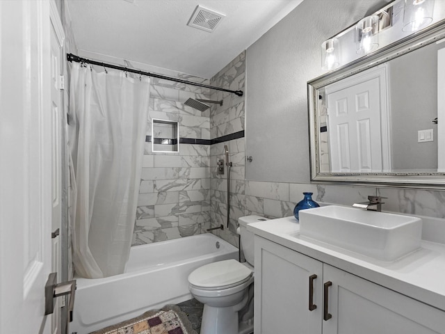 full bathroom with vanity, toilet, a textured ceiling, and shower / tub combo