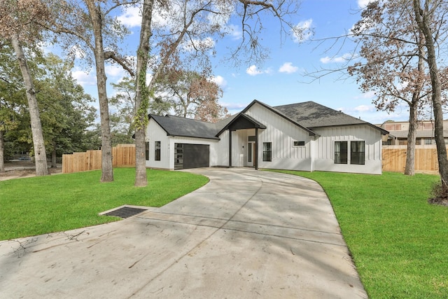 modern farmhouse featuring a garage and a front lawn