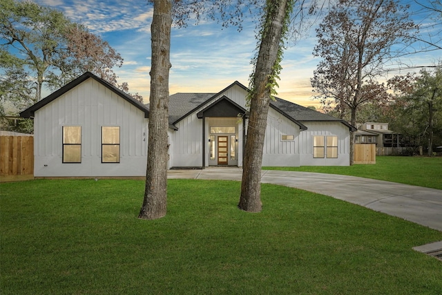 modern farmhouse style home with a lawn