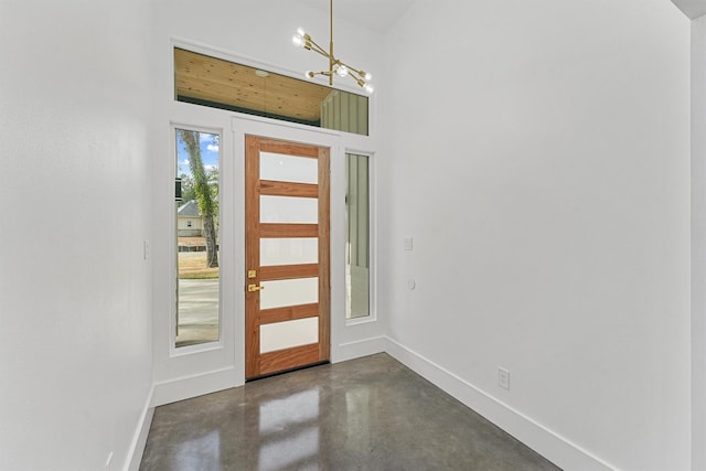 foyer with a wealth of natural light and a notable chandelier