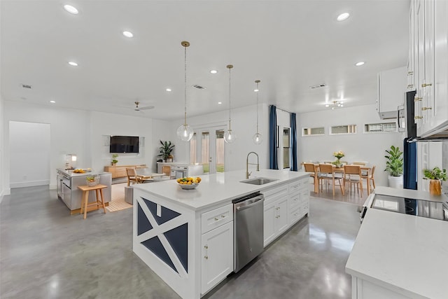 kitchen featuring white cabinets, a center island with sink, sink, stainless steel dishwasher, and decorative light fixtures