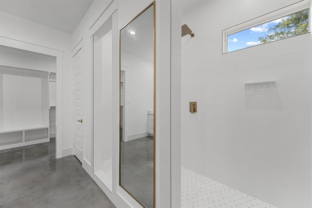 bathroom featuring a shower and concrete flooring