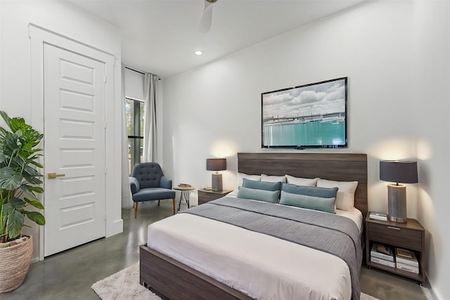 bedroom with ceiling fan and concrete flooring