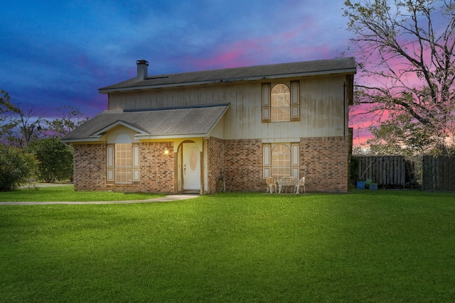 view of property featuring a lawn