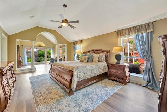 bedroom with ornate columns, ceiling fan, lofted ceiling, multiple windows, and light wood-type flooring