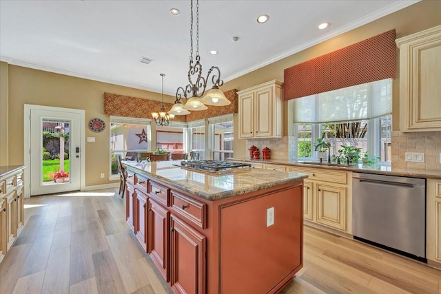 kitchen with decorative backsplash, a kitchen island, hanging light fixtures, and appliances with stainless steel finishes