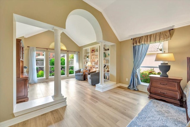 interior space with built in shelves, decorative columns, crown molding, light hardwood / wood-style floors, and vaulted ceiling