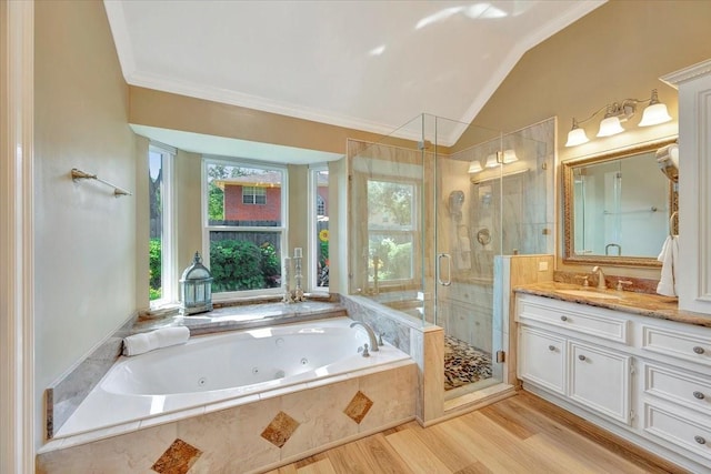 bathroom with crown molding, lofted ceiling, vanity, independent shower and bath, and hardwood / wood-style flooring