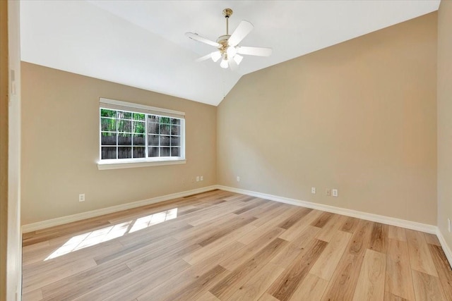 empty room with ceiling fan, light hardwood / wood-style flooring, and vaulted ceiling