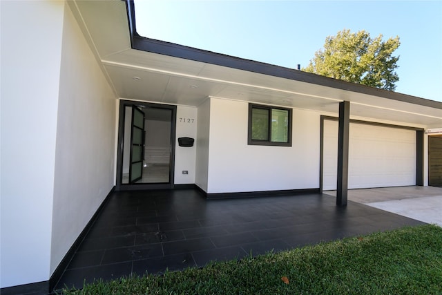 doorway to property with a garage