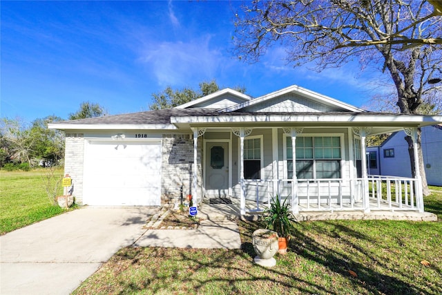 view of front of home featuring a front yard, a porch, and a garage