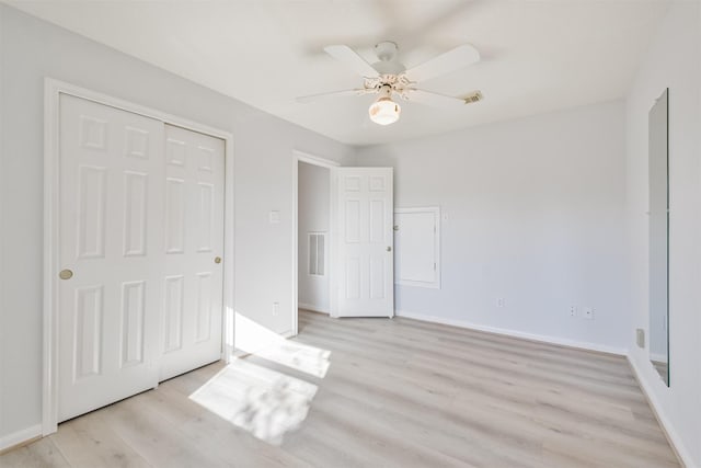 unfurnished bedroom featuring a closet, ceiling fan, and light hardwood / wood-style flooring