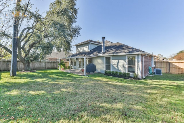 rear view of property with a lawn, central AC unit, and a patio