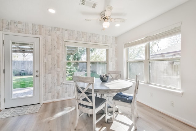 dining room with ceiling fan and light hardwood / wood-style floors