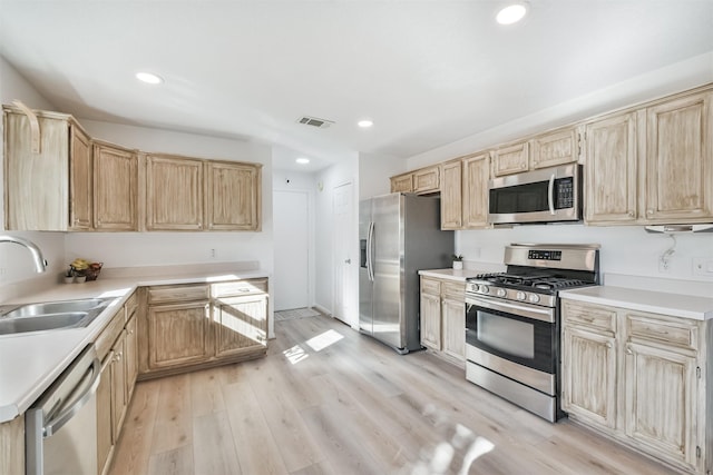 kitchen featuring light brown cabinets, stainless steel appliances, light hardwood / wood-style floors, and sink