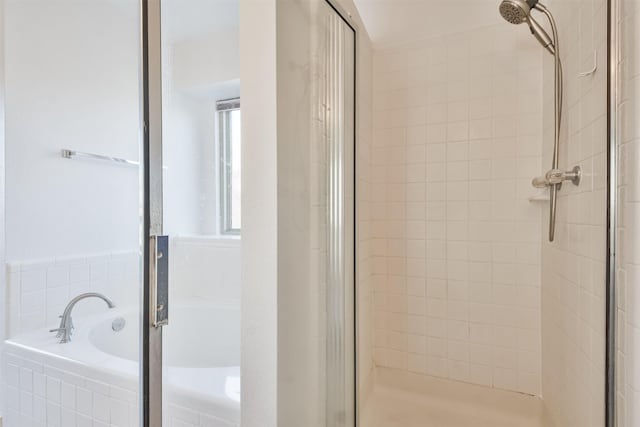 bathroom featuring separate shower and tub