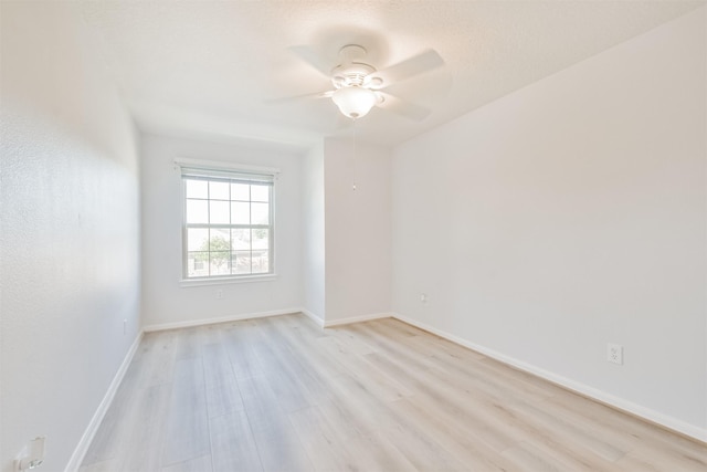 spare room featuring light hardwood / wood-style flooring and ceiling fan