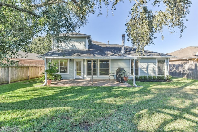 back of property featuring a lawn and a patio area