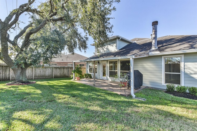 rear view of house featuring a patio and a lawn