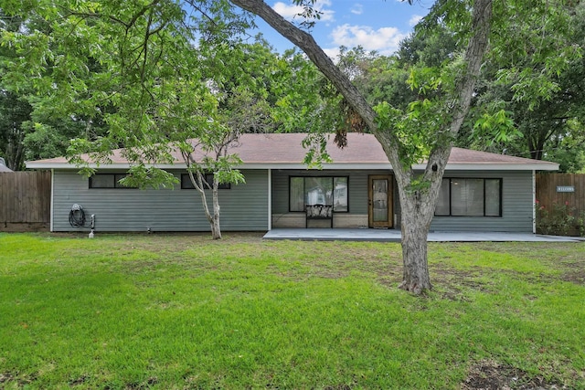 back of house featuring a patio, a lawn, and fence