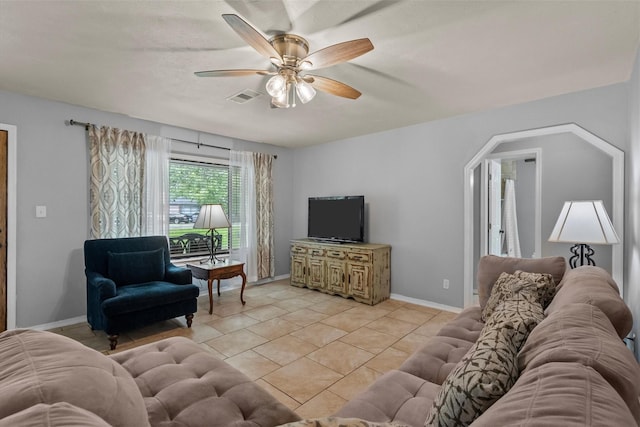 living room with light tile patterned floors, a ceiling fan, visible vents, and baseboards