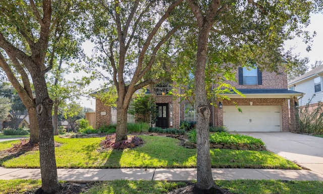 obstructed view of property featuring a front yard and a garage