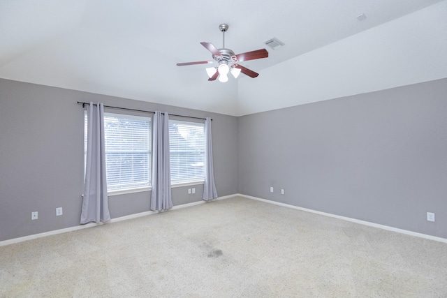 unfurnished room with ceiling fan, lofted ceiling, and light carpet