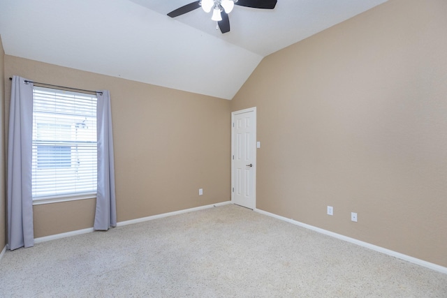 carpeted spare room featuring ceiling fan and lofted ceiling