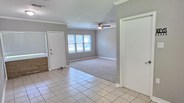 carpeted entryway featuring ceiling fan and crown molding