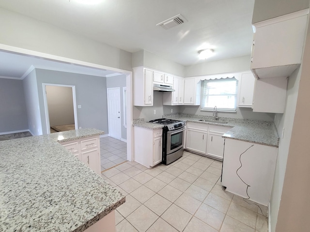 kitchen with sink, light stone countertops, light tile patterned floors, white cabinetry, and stainless steel range with gas stovetop