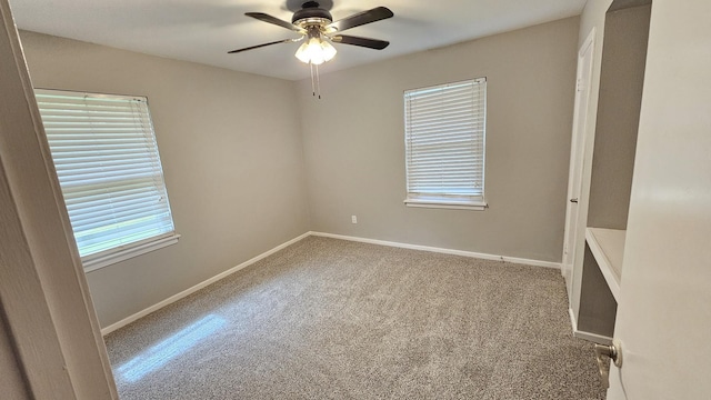 carpeted spare room with ceiling fan