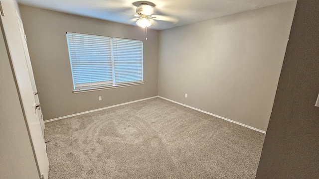 carpeted empty room featuring ceiling fan