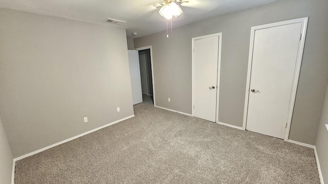 unfurnished bedroom featuring carpet floors and ceiling fan