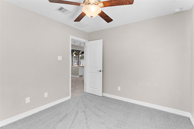 unfurnished room featuring light colored carpet and ceiling fan