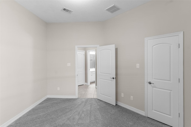 unfurnished bedroom with light colored carpet