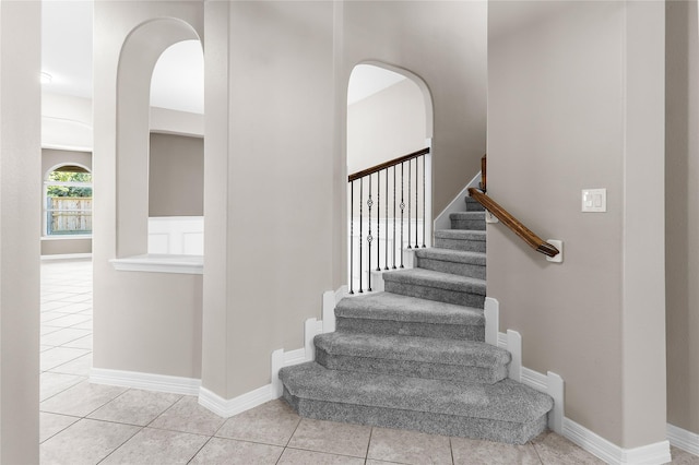 stairway featuring tile patterned flooring