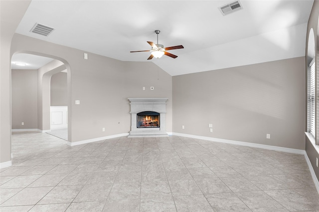 unfurnished living room with light tile patterned floors, vaulted ceiling, and ceiling fan